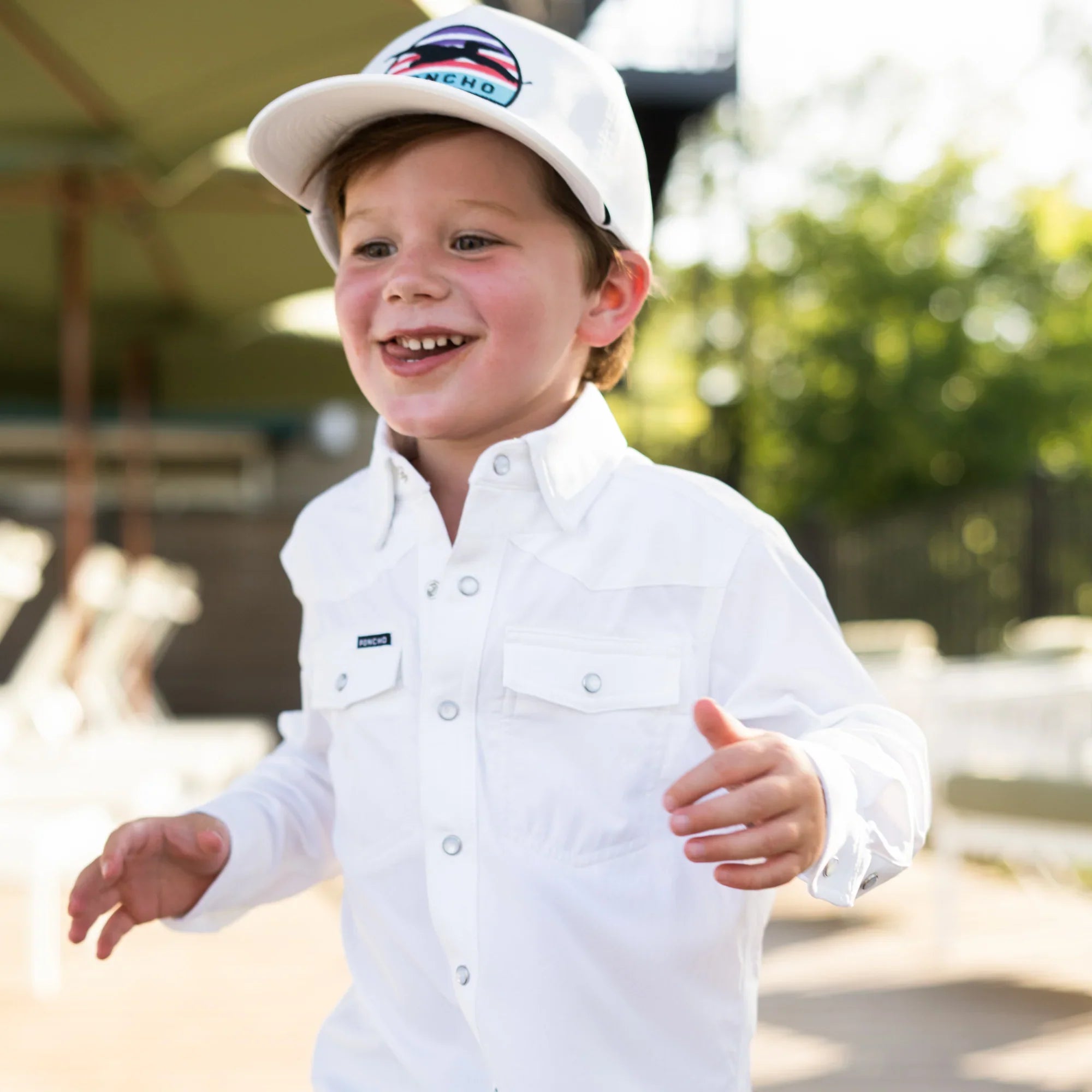 Kids New Arrivals - kid smiling in button down Poncho Outdoors shirt