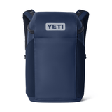 A navy blue YETI backpack shown from the front on a clean white background, featuring a white YETI logo patch on the front pocket.