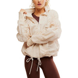 Woman wearing a beige jacket with a white background