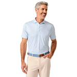 Man wearing a light blue polo shirt and beige pants on a white background