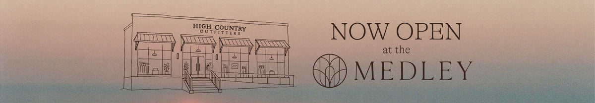 A promotional graphic with a simple line drawing of a storefront labeled 'High Country Coffee Shop' on the left, and the text 'NOW OPEN at the MEDLEY' on the right against a soft pink-to-blue gradient background.