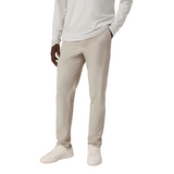 Person wearing beige pants and a white long-sleeve shirt on a white background