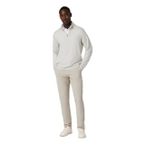 Man wearing a light gray sweater and pants on a white background