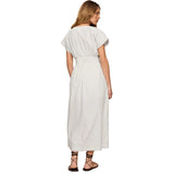 A woman shown from the back wearing a white midi dress with thin vertical gray stripes, short cap sleeves, and a matching waist belt. She is wearing dark brown strappy flat sandals against a plain light gray studio background.
