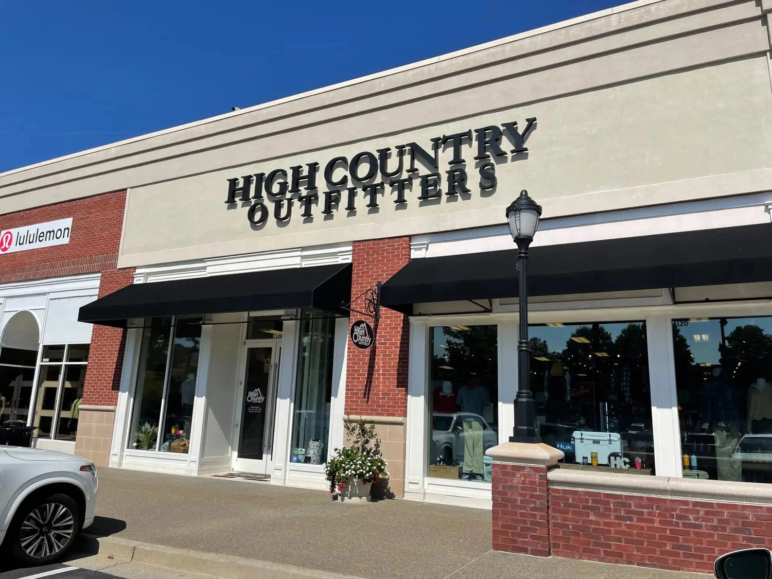 High Country Outfitters storefront with black lettering on a beige building facade.