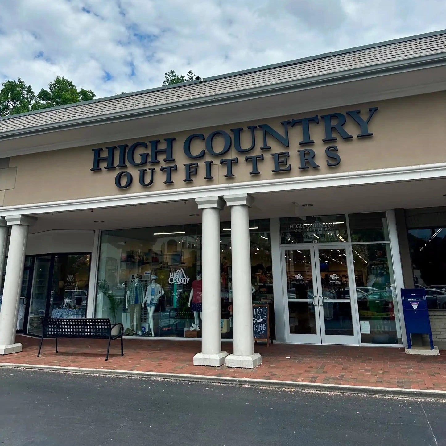 High Country Outfitters storefront with white columns and tan exterior.