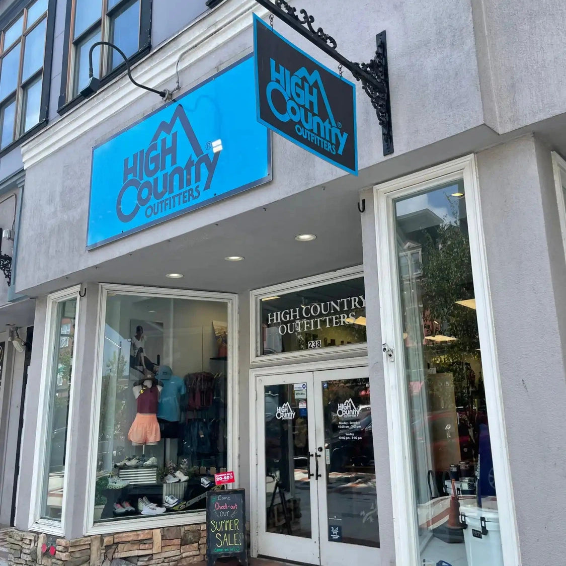 High Country storefront with bright blue signage and display windows.