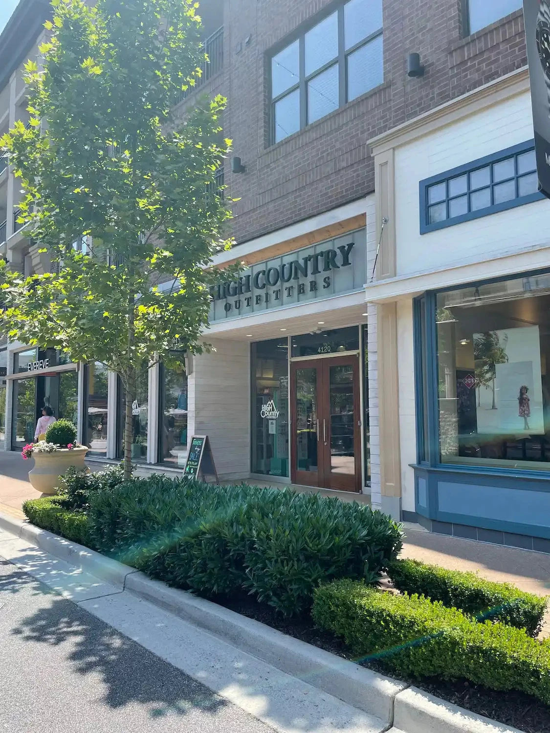 Town & Country clothing store storefront with brick exterior.